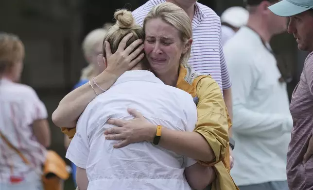 Families are reunited at a reunification center after flash flooding hit the area, Friday, July 4, 2025, in Ingram, Texas. (AP Photo/Eric Gay)