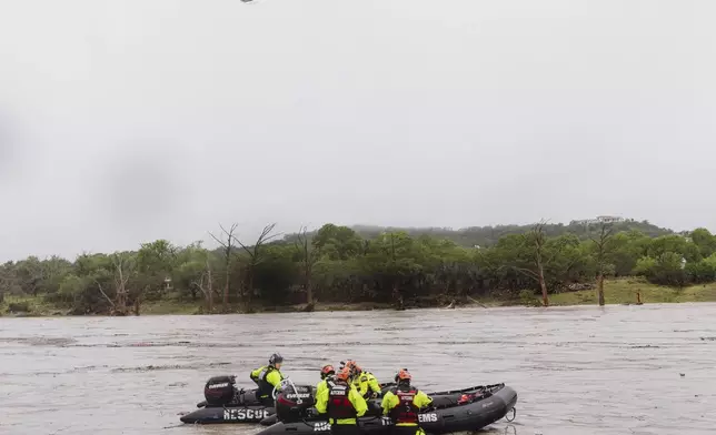 First responders deploy boats along the Guadalupe River after deadly flooding on Friday, July 4, 2025, in Kerrville, Texas. (Christopher Lee/The San Antonio Express-News via AP)