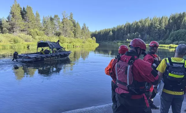 This photo provided by the Deschutes County Sheriff's Office shows search and rescue teams on the Deschutes River about 10 miles from Bend, Ore., after a fatal waterfall accident Saturday, July 19, 2025. (Deschutes County Sheriff's Office via AP)