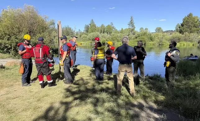 This photo provided by the Deschutes County Sheriff's Office shows search and rescue teams along the Deschutes River about 10 miles from Bend, Ore., after a fatal waterfall accident Saturday, July 19, 2025. (Deschutes County Sheriff's Office via AP)
