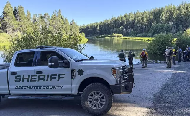 This photo provided by the Deschutes County Sheriff's Office shows search and rescue teams along the Deschutes River about 10 miles from Bend, Ore., after a fatal waterfall accident Saturday, July 19, 2025. (Deschutes County Sheriff's Office via AP)
