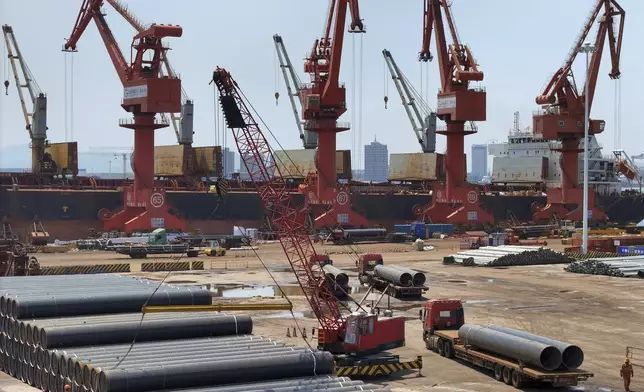 Steel pipes wait for shipment to overseas markets at a port in Longkou in east China's Shandong province on June 17, 2025. (Chinatopix via AP)