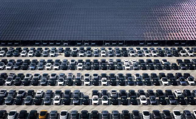 New cars wait for shipment in a parking lot partially covered by solar panels at the distribution center of Changan Auto, in southwest China's Chongqing Municipality on July 6, 2025. (Chinatopix via AP)