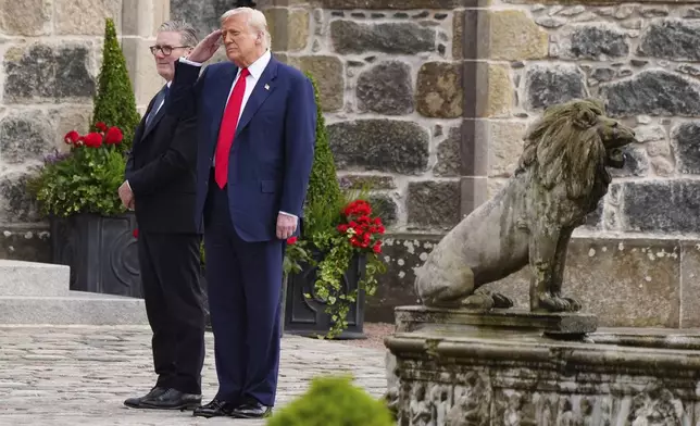 U.S. President Donald Trump, right, and British Prime Minister Keir Starmer walk at Trump International Golf Links in Aberdeenshire, Scotland, Monday, July 28, 2025. (Jane Barlow/Pool Photo via AP)