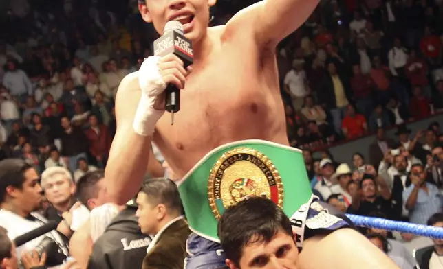 FILE - Mexican boxer Julio Cesar Chavez Jr. top, celebates with his team after defeating with U.S. Jose Celaya during their Continental Americas super welterweight title fight of the World Boxing Council (WBC) in Leon, Mexico, Feb. 9, 2008. (AP Photo/Mario Armas, File)