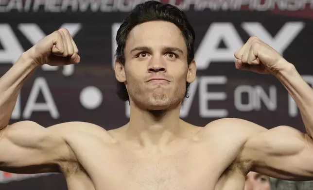 FILE - Julio Cesar Chavez Jr. poses for photographers during a weigh-in, in Las Vegas, May 5, 2017. (AP Photo/John Locher, File)