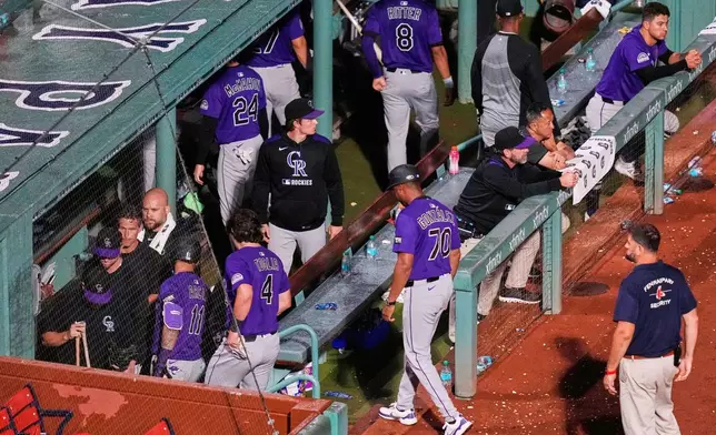 FILE - Colorado Rockies players leave the dugout after losing to the Boston Red Sox in a baseball game at Fenway Park, Wednesday, July 9, 2025, in Boston. (AP Photo/Charles Krupa, File)