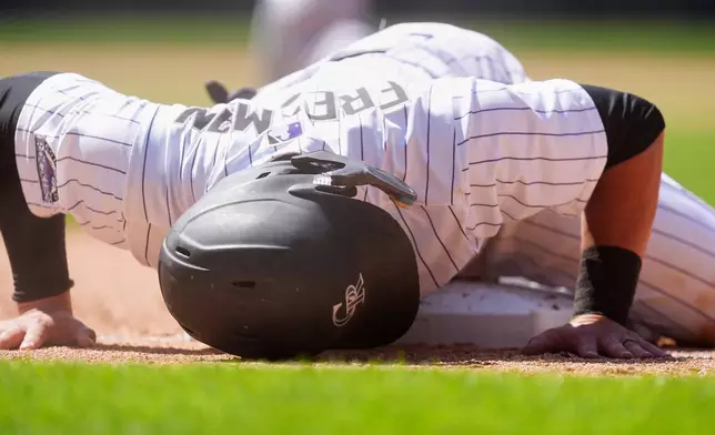 FILE - Colorado Rockies' Tyler Freeman reacts after being caught off first base on the back end of a double play hit into by Thairo Estrada to end a baseball game against the Los Angeles Dodgers, Thursday, June 26, 2025, in Denver. (AP Photo/David Zalubowski, File)