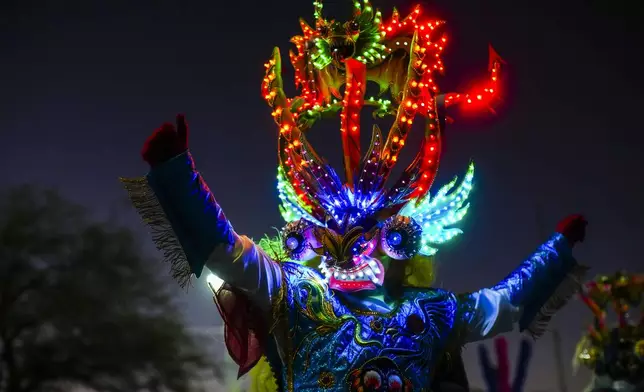 A Diablada dancer performs during a celebration of the Virgen de Carmen or Our Lady of Mount Carmel, Chile's patron saint, in La Tirana, Chile, Tuesday, July 15, 2025. (AP Photo/Esteban Felix)