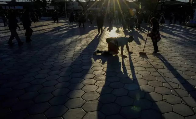 A parishioner crawls to church during a celebration of the Virgin of Carmel, Chile's patron saint, in La Tirana, Chile, Tuesday, July 15, 2025. (AP Photo/Esteban Felix)
