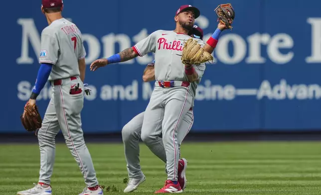 Philadelphia Phillies third baseman Edmundo Sosa, front, and outfielder Brandon Marsh (16) collide during the seventh inning of a baseball game against the Philadelphia Phillies, Saturday, July 26, 2025, in New York. (AP Photo/Yuki Iwamura)