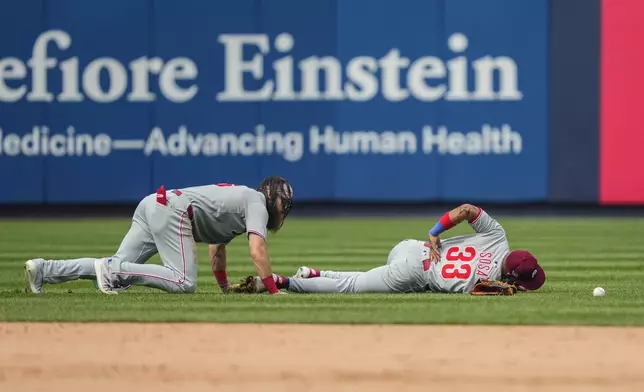 Philadelphia Phillies third baseman Edmundo Sosa (33) reacts after outfielder Brandon Marsh (16) collide during the seventh inning of a baseball game against the Philadelphia Phillies, Saturday, July 26, 2025, in New York. (AP Photo/Yuki Iwamura)