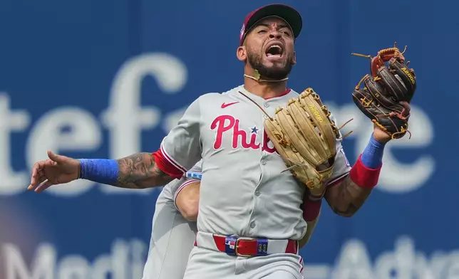 Philadelphia Phillies third baseman Edmundo Sosa, front, and outfielder Brandon Marsh (16) collide during the seventh inning of a baseball game against the Philadelphia Phillies, Saturday, July 26, 2025, in New York. (AP Photo/Yuki Iwamura)