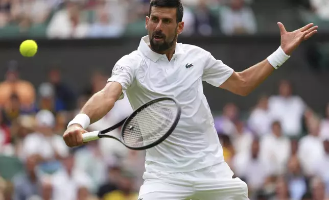 Novak Djokovic of Serbia returns to Miomir Kecmanovic of Serbia during a third round men's singles match at the Wimbledon Tennis Championships in London, Saturday, July 5, 2025. (AP Photo/Kirsty Wigglesworth)