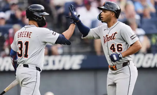 Detroit Tigers' Wenceel Pérez (46) is congratulated by teammate Riley Greene (31) after hitting a home run in the third inning of a baseball game against the Cleveland Guardians in Cleveland, Friday, July 4, 2025. (AP Photo/Sue Ogrocki)