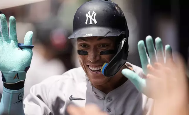 New York Yankees' Aaron Judge (99) celebrates his solo home run against the Atlanta Braves in the first inning of a baseball game, Sunday, July 20, 2025, in Atlanta. (AP Photo/Mike Stewart)