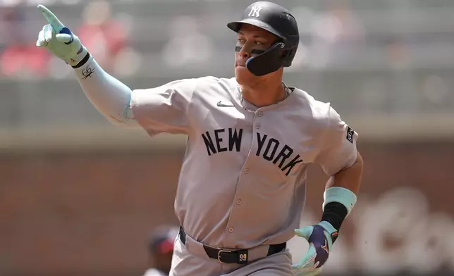 New York Yankees' Aaron Judge (99) celebrates his solo home run against the Atlanta Braves in the first inning of a baseball game, Sunday, July 20, 2025, in Atlanta. (AP Photo/Mike Stewart)