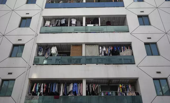Clothes dry on balconies of a residential building in Dubai, United Arab Emirates, Friday, July 4, 2025. (AP Photo/Altaf Qadri)