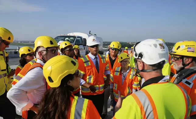 Maryland Gov. Wes Moore speaks with representatives of the Maryland Transportation Authority during a tour of the demolition work zone for the remaining portions of the Francis Scott Key Bridge, Wednesday, July 30, 2025, in Baltimore. (AP Photo/Stephanie Scarbrough)