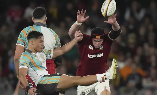 James Ryan of the British &amp; Irish Lions, right, attempts to block a kick by First Nations &amp; Pacifika XV's Kalani Thomas during their rugby union match in Melbourne, Australia, Tuesday, July 22, 2025. (AP Photo/Asanka Brendon Ratnayake)