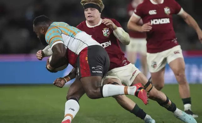 Henry Pollock of the British &amp; Irish Lions, right, tackles First Nations &amp; Pacifika XV's Mesake Doge during their rugby union match in Melbourne, Australia, Tuesday, July 22, 2025. (AP Photo/Asanka Brendon Ratnayake)