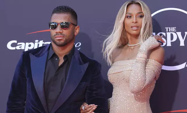 Russell Wilson, left, and his wife, Ciara, arrive at the ESPY Awards at the Dolby Theatre in Los Angeles, Wednesday, July 16, 2025. (AP Photo/Chris Pizzello)