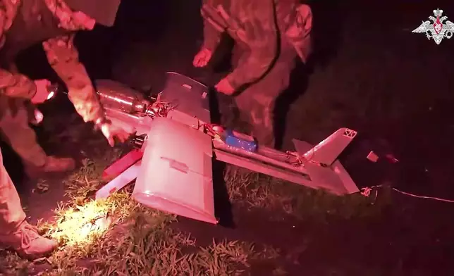 FILE - In this photo taken from video distributed by Russian Defense Ministry Press Service on July 18, 2025, Russian soldiers prepare a strike drone aircraft to fly toward Ukrainian positions in an undisclosed location. (Russian Defense Ministry Press Service via AP, File)