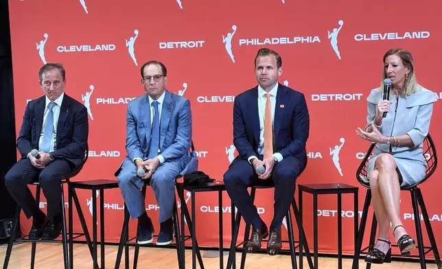 Josh Harris, left, managing partner of the Philadelphia 76ers, Arn Tellem, Detroit Pistons vice chairman, Nic Barlage, representing the Cleveland Cavaliers, listen as WNBA commissioner Cathy Engelbert speaks during a news conference, Monday, June 30, 2025, in New York, announcing WNBA basketball expansion teams in Philadelphia, Detroit and Cleveland. (AP Photo/Doug Feinberg)