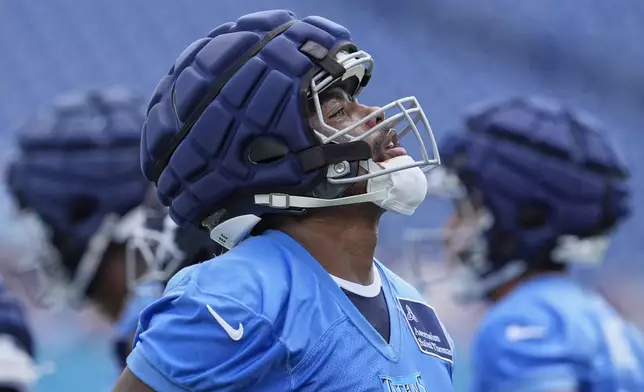 Tennessee Titans wide receiver Treylon Burks (16) looks up during "Back Together Weekend" at the team's NFL football training camp Saturday, July 26, 2025, in Nashville, Tenn. (AP Photo/George Walker IV)
