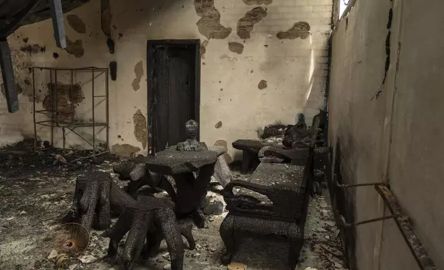 A bust of Buddha among remains charred inside a bombed building in O'Smach, Oddar Meanchey in Cambodia, on Wednesday, July 30, 2025. (AP Photo/Anton L. Delgado)