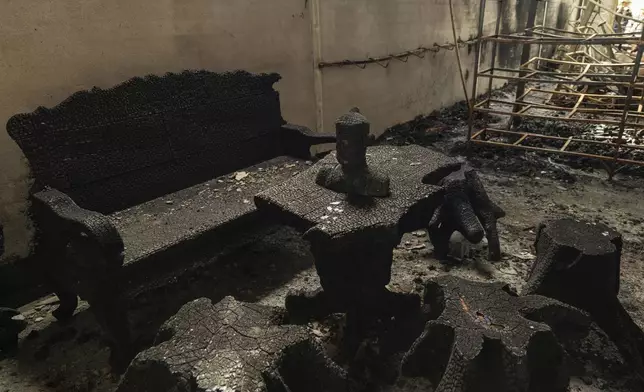 A bust of Buddha is left charred in a bombed building in O'Smach, Oddar Meanchey in Cambodia on Wednesday, July 30, 2025. (AP Photo/Anton L. Delgado)
