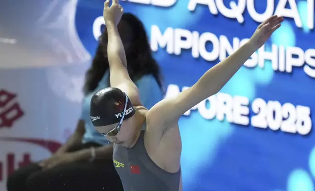 Yu Zidi of China warms up to compete in the women's 200-meter individual medley heat at the World Aquatics Championships in Singapore, Sunday, July 27, 2025. (AP Photo/Lee Jin-man)