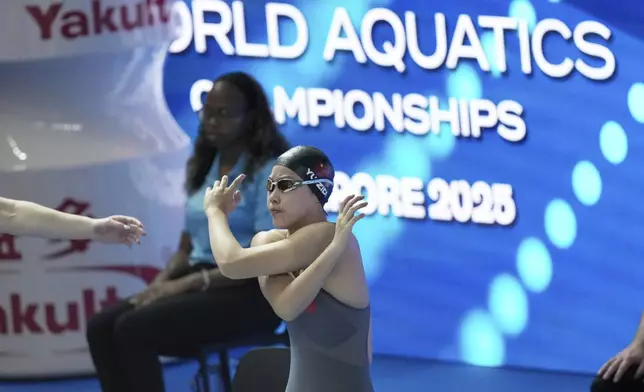 Yu Zidi of China warms up to compete in the women's 200-meter individual medley heat at the World Aquatics Championships in Singapore, Sunday, July 27, 2025. (AP Photo/Lee Jin-man)
