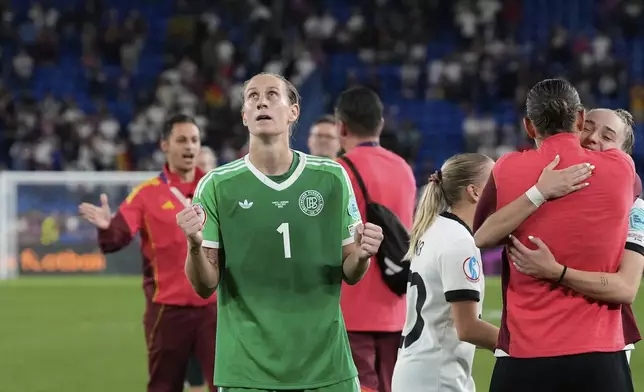 Germany goalkeeper Ann-Katrin Berger celebrates in front of the fans after winning the Women's Euro 2025 quarterfinals soccer match between France and Germany at St. Jakob-Park in Basel, Switzerland, Saturday, July 19, 2025. (AP Photo/Alessandra Tarantino)