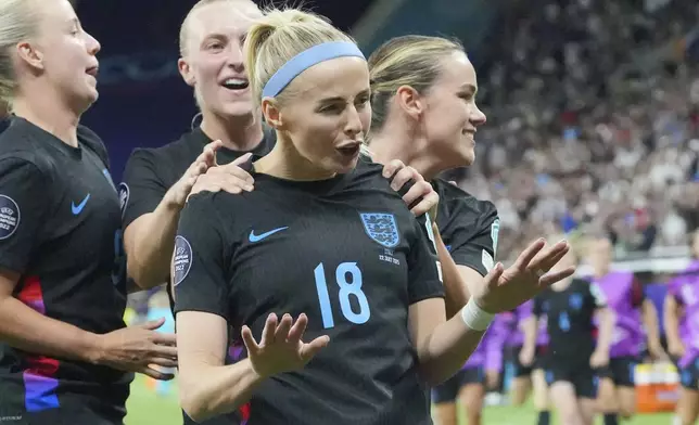 England's Chloe Kelly is celebrated after she scored the decisive second goal for England during the Women's Euro 2025 semifinals soccer match between England and Italy at Stade de Geneve in Geneva, Switzerland, Tuesday, July 22, 2025. (AP Photo/Martin Meissner)