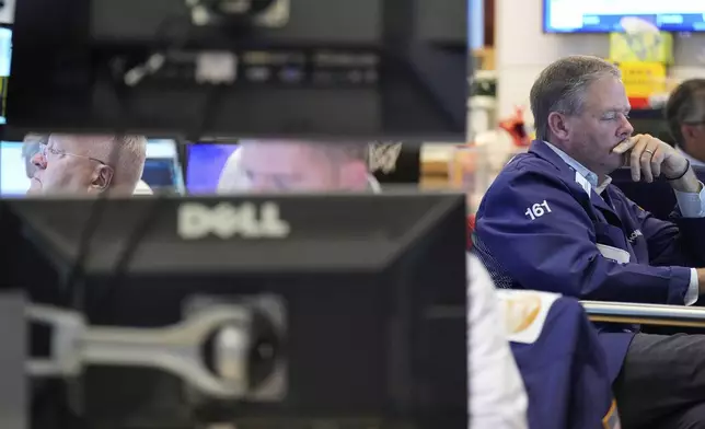 Traders work on the floor at the New York Stock Exchange in New York, Wednesday, July 30, 2025. (AP Photo/Seth Wenig)