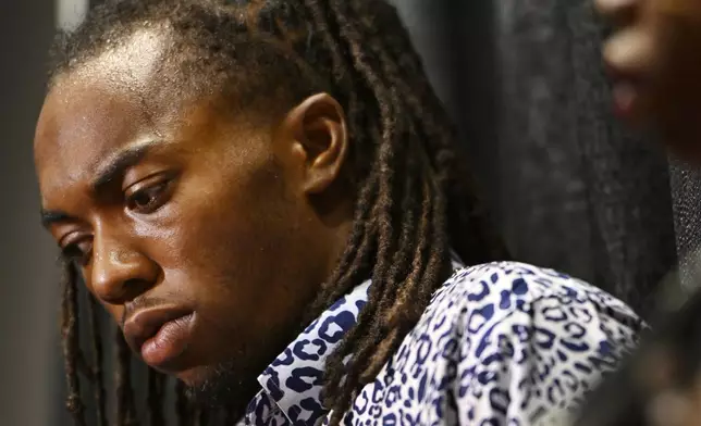 William McNeil Jr. looks on while standing next to his mother Latoya Solomon during a press conference Tuesday, July 29, 2025, in Chicago. (AP Photo/Paul Beaty)