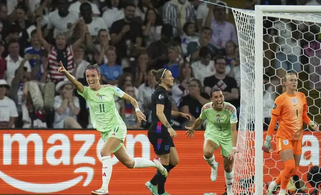 Italy's Barbara Bonansea, left, celebrates after scoring the opening goal during the Women's Euro 2025 semifinals soccer match between England and Italy at Stade de Geneve in Geneva, Switzerland, Tuesday, July 22, 2025. (AP Photo/Alessandra Tarantino)