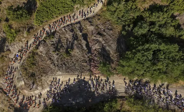 People participate in the "March of Peace" to remember the 1995 Srebrenica genocide, in Nezuk, Bosnia, Tuesday, July 8, 2025. (AP Photo/Armin Durgut)