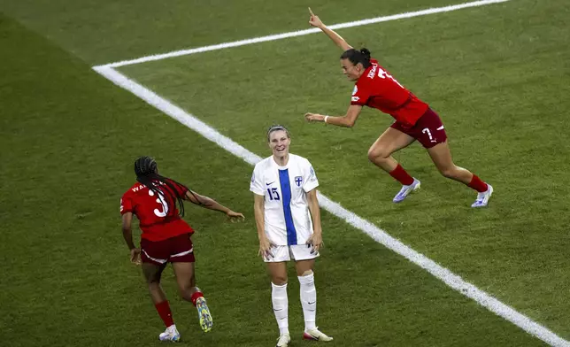 Switzerland's Riola Xhemaili, right, celebrates after scoring her side's goal while Finland 's Natalia Kuikka reacts, during the Euro 2025, group A, soccer match between Finland and Switzerland in Geneva, Switzerland, Thursday, July 10, 2025. (Martial Trezzini/Keystone via AP)