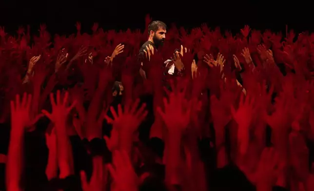 Iranian Shiite Muslims mourn in a ceremony in Tehran Iran, on Saturday, July 5, 2025, on the eve of Ashoura, the death anniversary of Prophet Muhammad's grandson, Hussein, who was killed with his 72 companions in a 7th-century battle in Karbala in present-day Iraq. (AP Photo/Vahid Salemi)