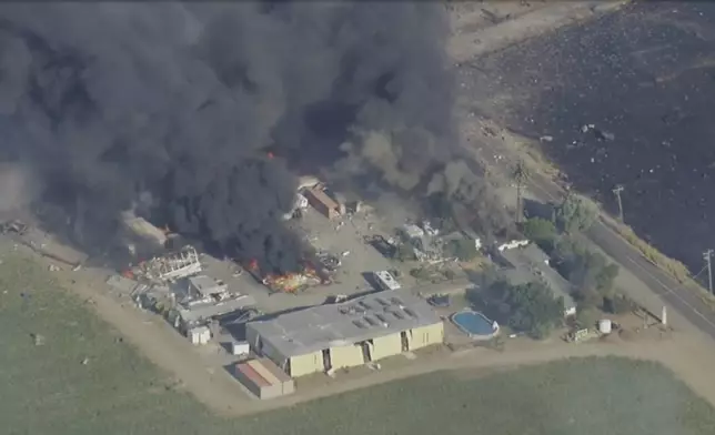 Smoke and flames rise at a fireworks warehouse near Esparto, Calif., on Tuesday, July 1, 2025. (KGO via AP)