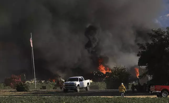 Smoke and flames rise during a fireworks warehouse explosion near Esparto, Calif., Tuesday, July 1, 2025. (Kent Porter/The Press Democrat via AP)