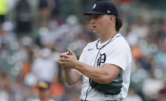 Detroit Tigers' Tyler Holton rubs a ball after giving up a home run to Seattle Mariners' Mitch Garver during the seventh inning of a baseball game Sunday, July 13, 2025, in Detroit. (AP Photo/Duane Burleson)