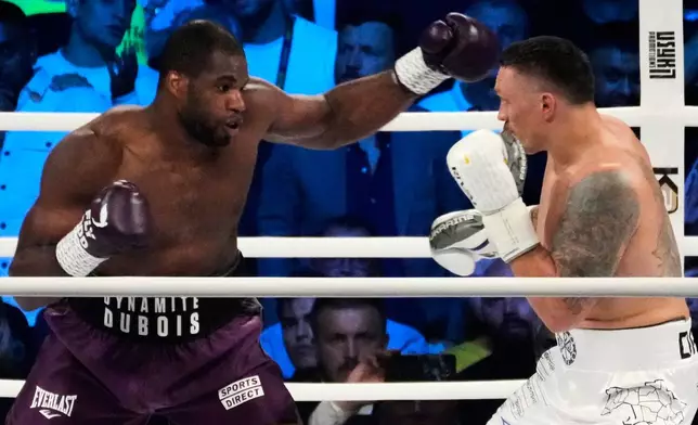 FILE - Britain's Daniel Dubois, left, and Ukraine's Oleksandr Usyk fight during their world heavyweight title fight at Tarczynski Arena in Wroclaw, Poland, Aug. 26, 2023. (AP Photo/Czarek Sokolowski, File)