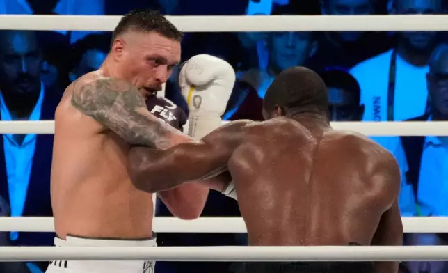 FILE - Ukraine's Oleksandr Usyk lands a blow on Britain's Daniel Dubois during their world heavyweight title fight at Tarczynski Arena in Wroclaw, Poland, Aug. 26, 2023. (AP Photo/Czarek Sokolowski, File)