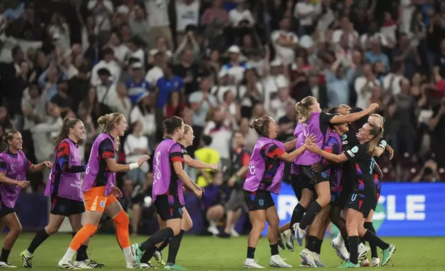 England players celebrate after Michelle Agyemang scored their side's first goal during the Women's Euro 2025 semifinals soccer match between England and Italy at Stade de Geneve in Geneva, Switzerland, Tuesday, July 22, 2025. (AP Photo/Alessandra Tarantino)