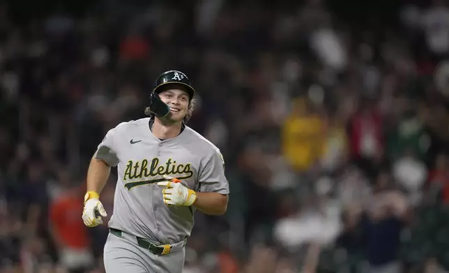 Athletics' Nick Kurtz smiles after hitting a three-run home against the Houston Astros during the ninth inning of a baseball game Friday, July 25, 2025, in Houston. (AP Photo/David J. Phillip)