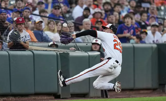 Baltimore Orioles third baseman Ramon Urias (29) catches a pop out in foul territory hit by New York Mets' Ronny Mauricio during the ninth inning in the second baseball game of a doubleheader, Thursday, July 10, 2025, in Baltimore. (AP Photo/Stephanie Scarbrough)