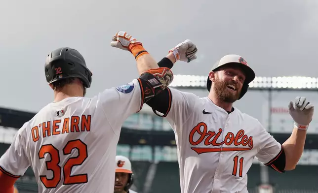 Baltimore Orioles' Jordan Westburg (11) celebrates with Ryan O'Hearn (32) after hitting a two-run home run during the second inning in the second baseball game of a doubleheader against the New York Mets, Thursday, July 10, 2025, in Baltimore. (AP Photo/Stephanie Scarbrough)